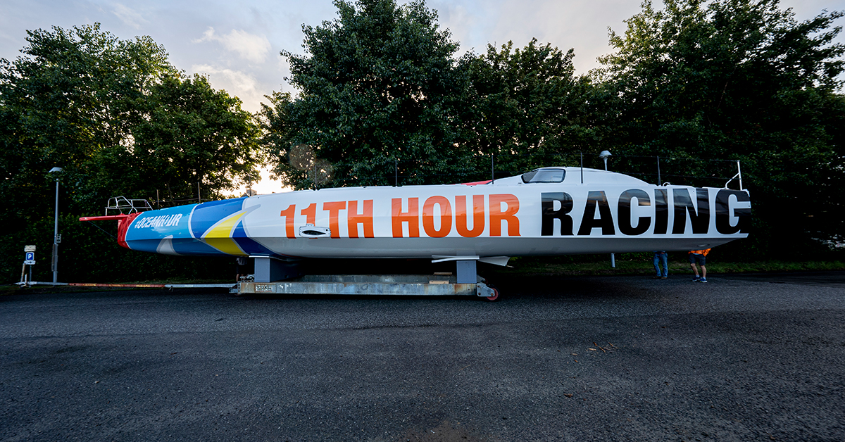 11th Hour Racing’s new IMOCA is rolled out of the shed at CDK Technologies in Port La Foret, France, to see sunlight for the first time. Photo credit: Amory Ross/ 11th Hour Racing