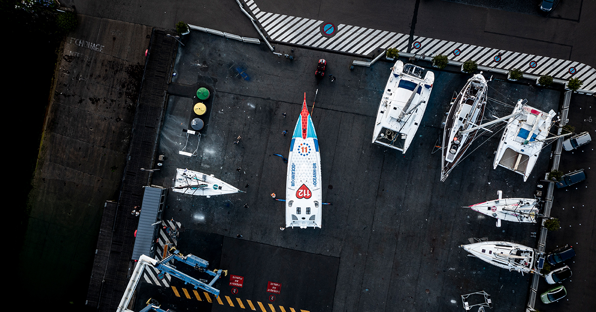 August 07, 2021. 11th Hour Racing’s new IMOCA is rolled out of the shed at CDK Technologies in Port La Foret to see sunlight for the first time. Photo by Ben Bireau / 11th Hour Racing